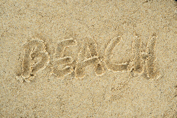 word beach written on the beach sand