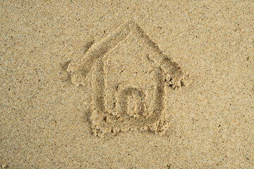 House drawn on beach sand