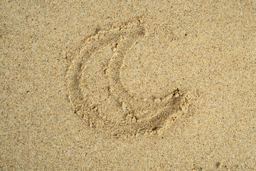 moon drawn on beach sand