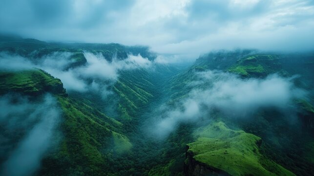 A misty morning view of Raigad Killa, with clouds rolling over the hills.