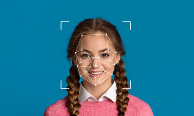 A young woman with braided hair smiles against a solid blue background, showcasing facial...