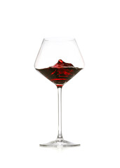 Red wine splashing in glass on white background