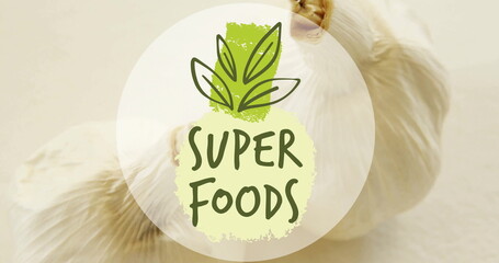 Image of super foods text over garlic on white background