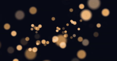 Image of glowing light spots moving over black background