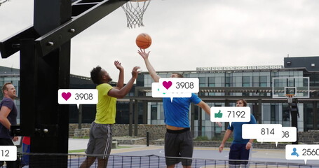 Image of social media notifications over diverse male basketball players on outdoor court