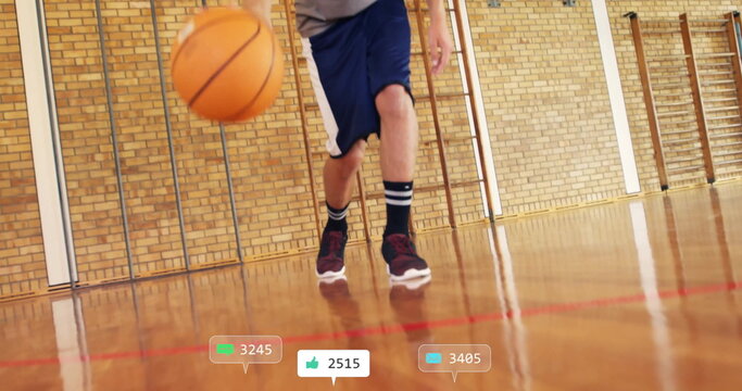 Image of social media notifications over caucasian male basketball player bouncing ball
