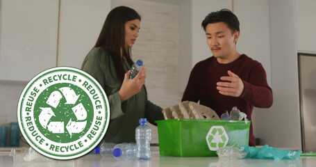 Image of recycle sign over happy diverse couple recycling at home