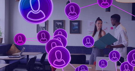 Image of network of people icons over diverse business people in office