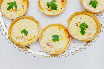 Delicious Mini Quiche Florentine served on a plate, featuring a golden crust filled with spinach and creamy cheese. A perfect bite-sized treat for brunch, parties, or any special occasion.