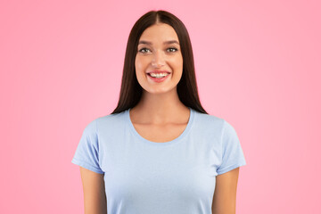 Fototapeta premium Closeup portrait of lovely lady smiling and looking at camera over yellow studio background. Happy caucasian woman with candid smile posing, female model showing positive emotions.