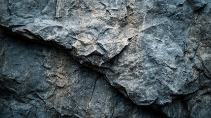 Fototapeta premium Close-up of rough, textured gray rock surface.