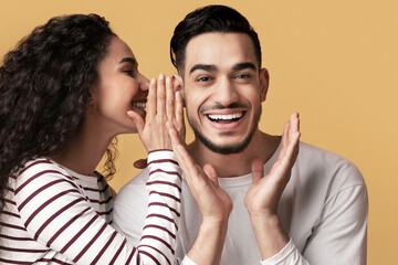 Gossips Concept. Lady Sharing Secret With Her Excited Arab Boyfriend, Joyful Middle Eastern Man...