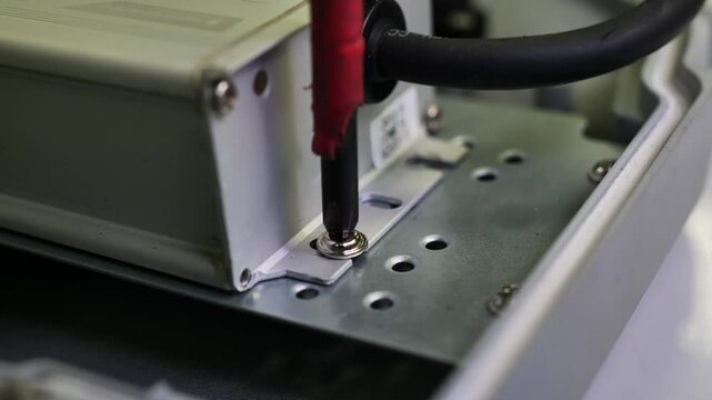 4K video of an electrician tightening screws to secure electrical components with precision. Ideal for safety training, technical tutorials, industrial content, and educational videos