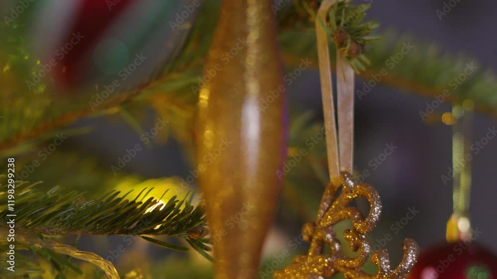 Poster close up with shallow depth of field of christmas fir tree with bourballs and bright xmas lights on 