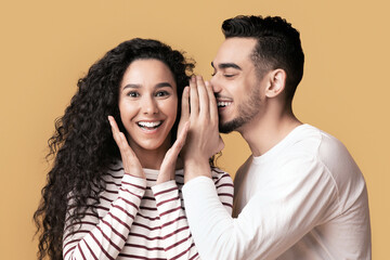 Big Secret. Young Arab Man Sharing News With His Excited Girlfriend, Surprised Middle Eastern Woman...