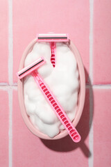 Decorative bathtub with a pink razor for shaving