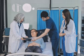 A team of doctors and nurses are working to treat a female patient in the patient's room.