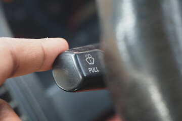 Hand Activating Windshield Wiper Control in a Vehicle for Better Visibility