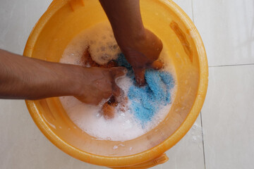 Fototapeta premium Hands are Washing Various Items in Soapy Water for Cleaning Purposes