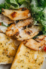 Caesar salad served in white plate on table