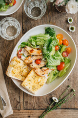 Caesar salad served in white plate on table