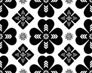 Bold black and white floral pattern featuring hearts and geometric shapes, creating striking visual effect. Perfect for textiles, wallpapers, and modern design projects