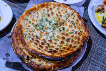 Roghni Naan is softer, thicker, and richer than plain naan, has a beautiful golden shine on it, and is covered with sesame seeds served warm.