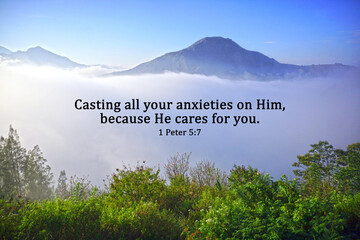 Bible verse quote - Casting all your anxieties on Him, because He cares for you. 1 Peter 5:7 on blue mountains nature background with fog and green forest. Christianity. Believe in God concept.