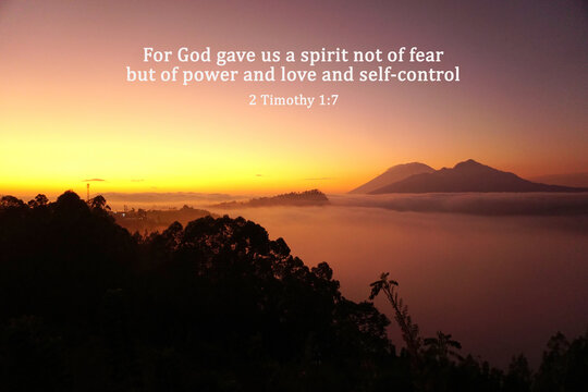 Bible verse quote - For God gave us a spirit not of fear but of power and love and self-control. 2 Timothy 1:7 on golden sunrise background over mountain with fog. Christianity.