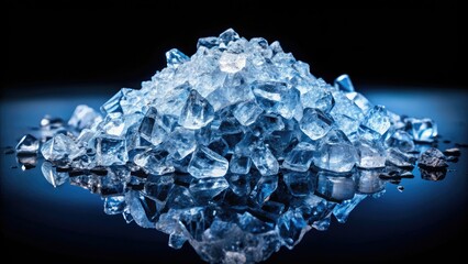 High-angle shot of a glistening glacial ice heap, crushed and meticulously textured, stark against a black backdrop.