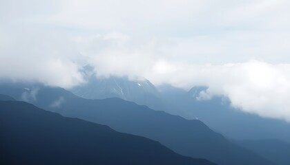 Fototapeta premium Misty Mountains Enveloped In Soft White Clouds