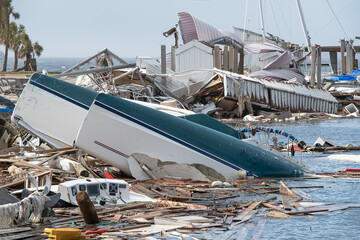 "Massive devastation at a marina as boats lie overturned and shattered, the aftermath of Hurricane Michael's unrelenting force."
