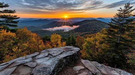 Breathtaking Sunrise Over Colorful Autumn Mountains with Mist and Clouds in a Serene Landscape at Dawn