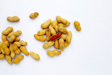 Roasted peanuts in shell on white background.