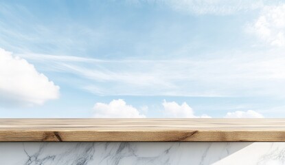 Wooden table top on marble base against a bright blue sky with clouds.
