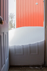 snow drift outside an open door