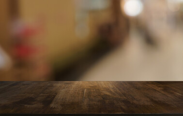 Empty wood table top and blur of restaurant background selective focus product display