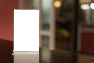 Menu mock up blank for text marketing promotion. Mock up Menu frame standing on wood table in restaurant space for text