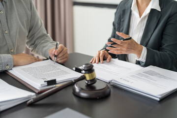 Lawyer Legal counsel presents to the client a signed contract with gavel and legal law. justice and lawyer Business partnership meeting concept