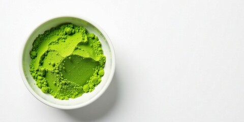 Obraz premium A small bowl of vibrant green powder, finely textured and subtly mountainous, sits against a pristine white backdrop, offering a tranquil and visually appealing image.
