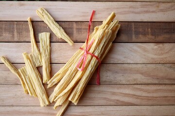 Soy bean curd sticks on wood background