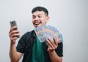 Excitement and Joyful Expression Captured in a Portrait of a Young Man Holding Money