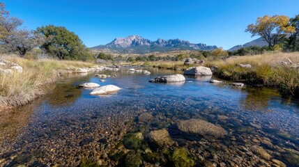 Obraz premium Calm river flows through desert landscape, mountains backdrop, clear water. Use Travel brochure