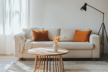 Minimalist living room, bright natural light white walls soft beige sofa orange cushions
