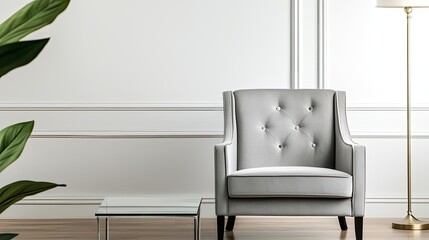Living interior concept. Elegant gray armchair in a modern living space with a stylish lamp and plant.