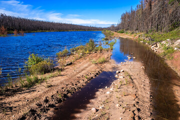 A body of water with a dirt road running along its edge