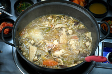 식탁 위에서 만두 전골을 맛있게 끊이고 있는 모습