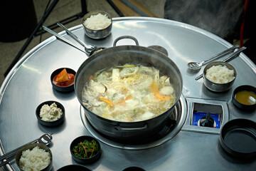 식탁 위에서 만둣국을 맛있게 끊이고 있는 모습