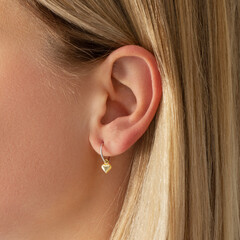 A Delicate HeartShaped Earring Featured on a Stylish Model Showcasing Its Beauty