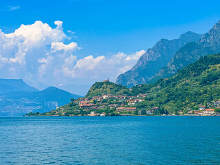 View of Iseo Lake Surrounded by Majestic Mountains and Clear Blue Skies, Italy